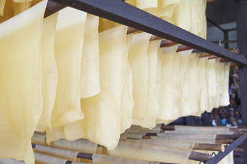 Closed up of rubber sheets hanging on the racks.
