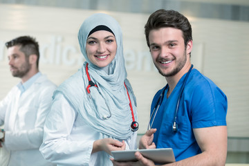 Saudi arab doctors working with a tablet.