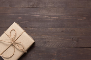 Gift box is on the wooden background with empty space