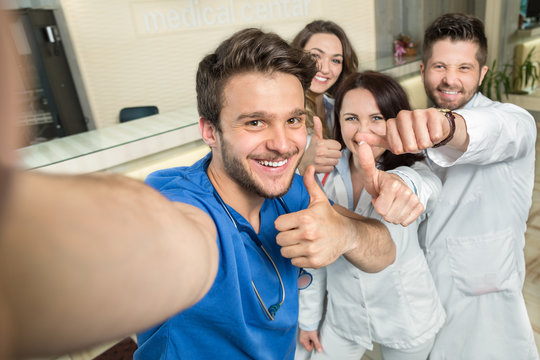 Smiling Team Of Doctors And Nurses At Hospital Taking Selfie