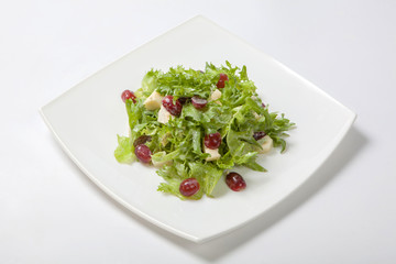 Fresh salad of lettuce with sweet sauce with pieces of fruit