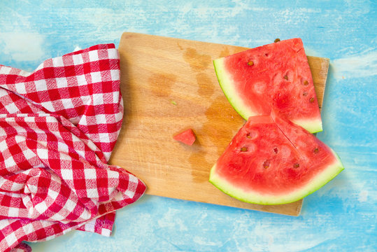 Watermelon slices on wooden board, top view