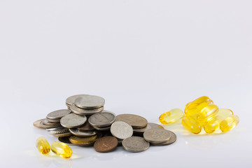 coins and pills on white background. The increase in drug prices