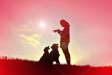 Silhouette women playing with dog