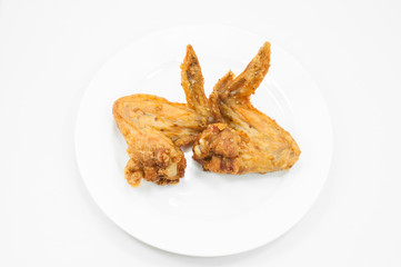 a pair of fried chicken wings on dish white