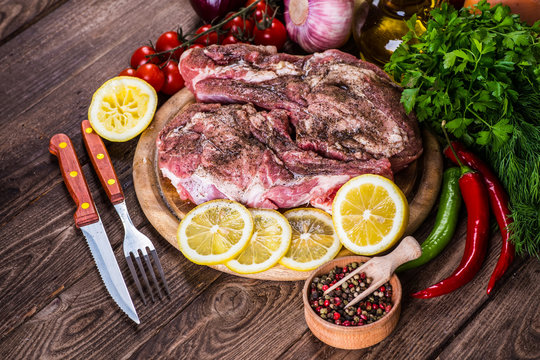 Raw marbled meat steak Ribeye on dark wooden background