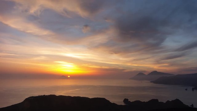 4K time lapse of a spectacular sunset behind an island in the Mediterranean sea, Sicily, Italy