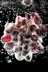 Black grapes surrounded by water bubbles