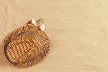Fototapeta na wymiar Summer hat put on the tropical sand beach