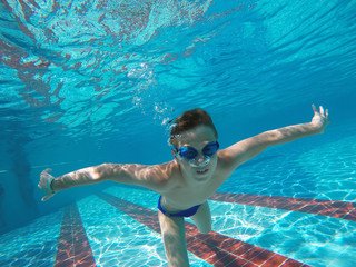 boy diving into a swimming pool