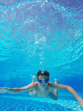 boy diving into a swimming pool