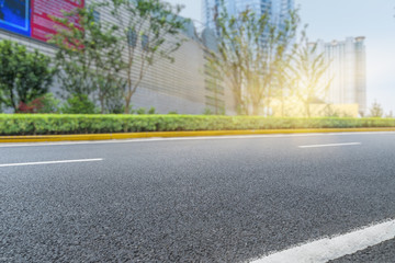 clean asphalt road with city skyline background,china.