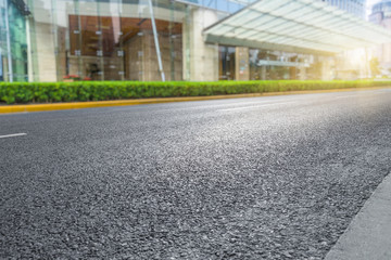 clean asphalt road with city skyline background,china.