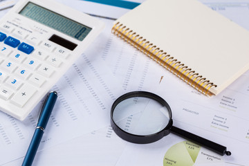 work with a magnifying glass, a calculator and papers