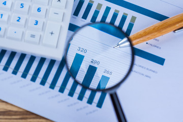 Calculator and magnifying glass on the table