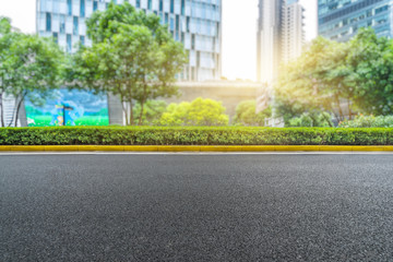 clean asphalt road with city skyline background,china.