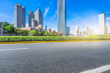 Fototapeta na wymiar clean asphalt road with city skyline background,china.