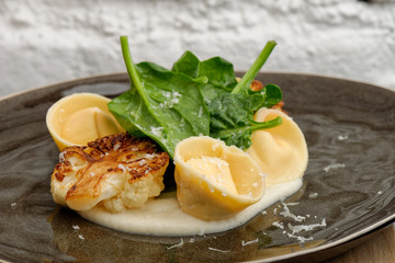 Fine dining, ravioli with cauliflower and fresh spinach