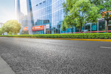 clean asphalt road with city skyline background,china.