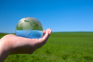 Glass earth in human hand