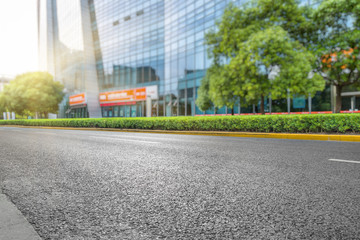 clean asphalt road with city skyline background,china.