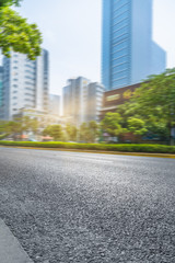 clean asphalt road with city skyline background,china.