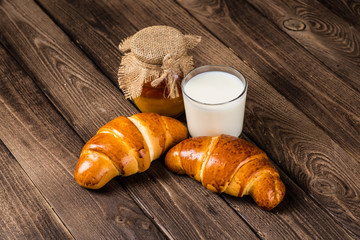 Assortment of baked bread on wooden table background