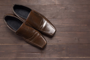 Leather shoes are on the wooden background