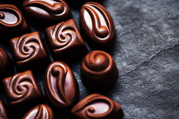 Luxury Chocolate over black background. Chocolate Candy, Cocoa.