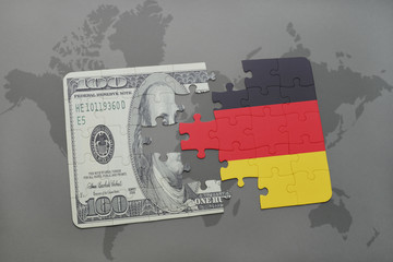 puzzle with the national flag of germany and dollar banknote on a world map background.