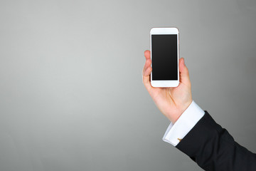 Close up of a businessman using mobile smart phone