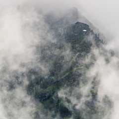 Thick Clouds Part to Reveal Mountain Top