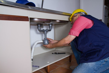 plumber at work with a sink