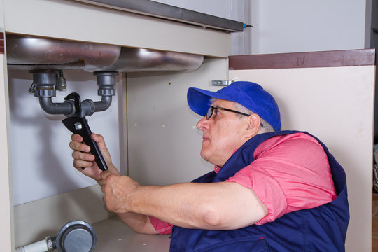 plumber at work with a sink