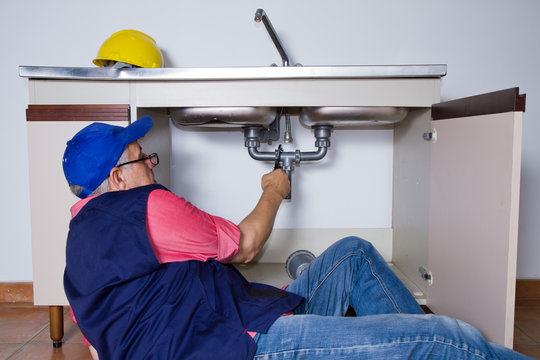 plumber at work with a sink