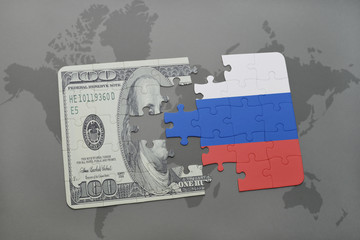 puzzle with the national flag of russia and dollar banknote on a world map background.