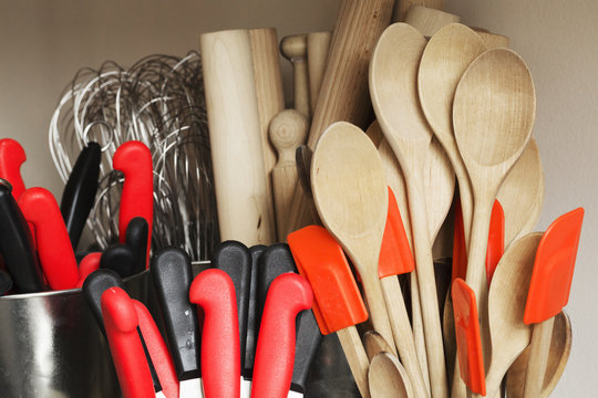 Selection of cooking utensils, wooden spoons, spatulas, rolling pins, whisks and kitchen knives.