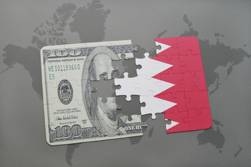 puzzle with the national flag of bahrain and dollar banknote on a world map background.