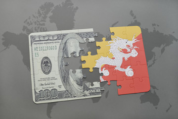 puzzle with the national flag of bhutan and dollar banknote on a world map background.