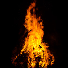 Wooden house roof in fire  on black background