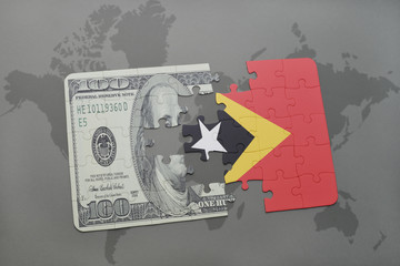 puzzle with the national flag of east timor and dollar banknote on a world map background.