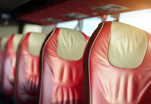 Empty red leather seats in tourist bus.