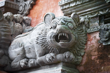 Animal like a dog on the wall of temple. Bali, Indonesia