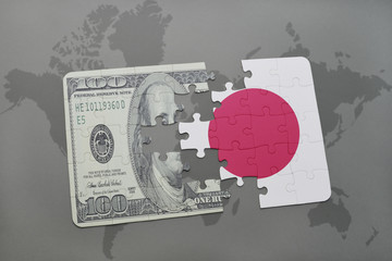 puzzle with the national flag of japan and dollar banknote on a world map background.