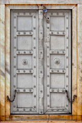 Agra, India. The old gray wooden door
