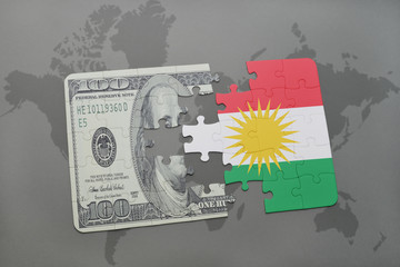 puzzle with the national flag of kurdistan and dollar banknote on a world map background.