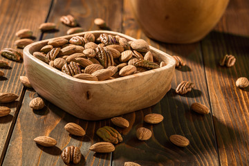 The nuts on a wooden background
