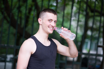 Handsome athlete man drinking water