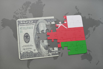 puzzle with the national flag of oman and dollar banknote on a world map background.