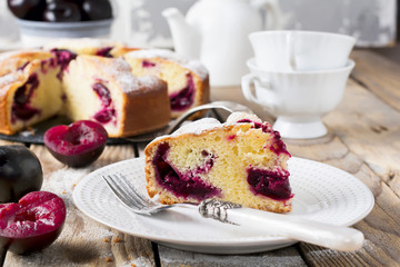 Plum cake on an old wooden table. Rustic style. Selective focus.